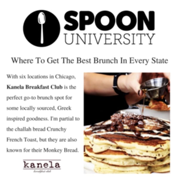 A hand pours syrup over a stack of Kanela Breakfast Club pancakes topped with chocolate and powdered sugar.