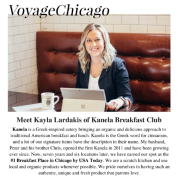Kayla Lardakis of Kanela Breakfast Club smiles, seated at a table with a laptop and coffee mug.